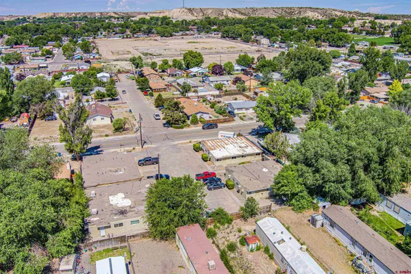 an aerial view of a house with garden space and street view