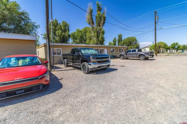 a view of a house with backyard and a parking space