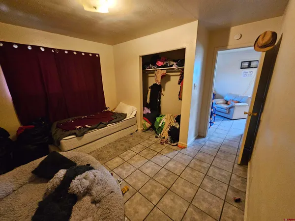 a bedroom with a bed and a mirror on dresser