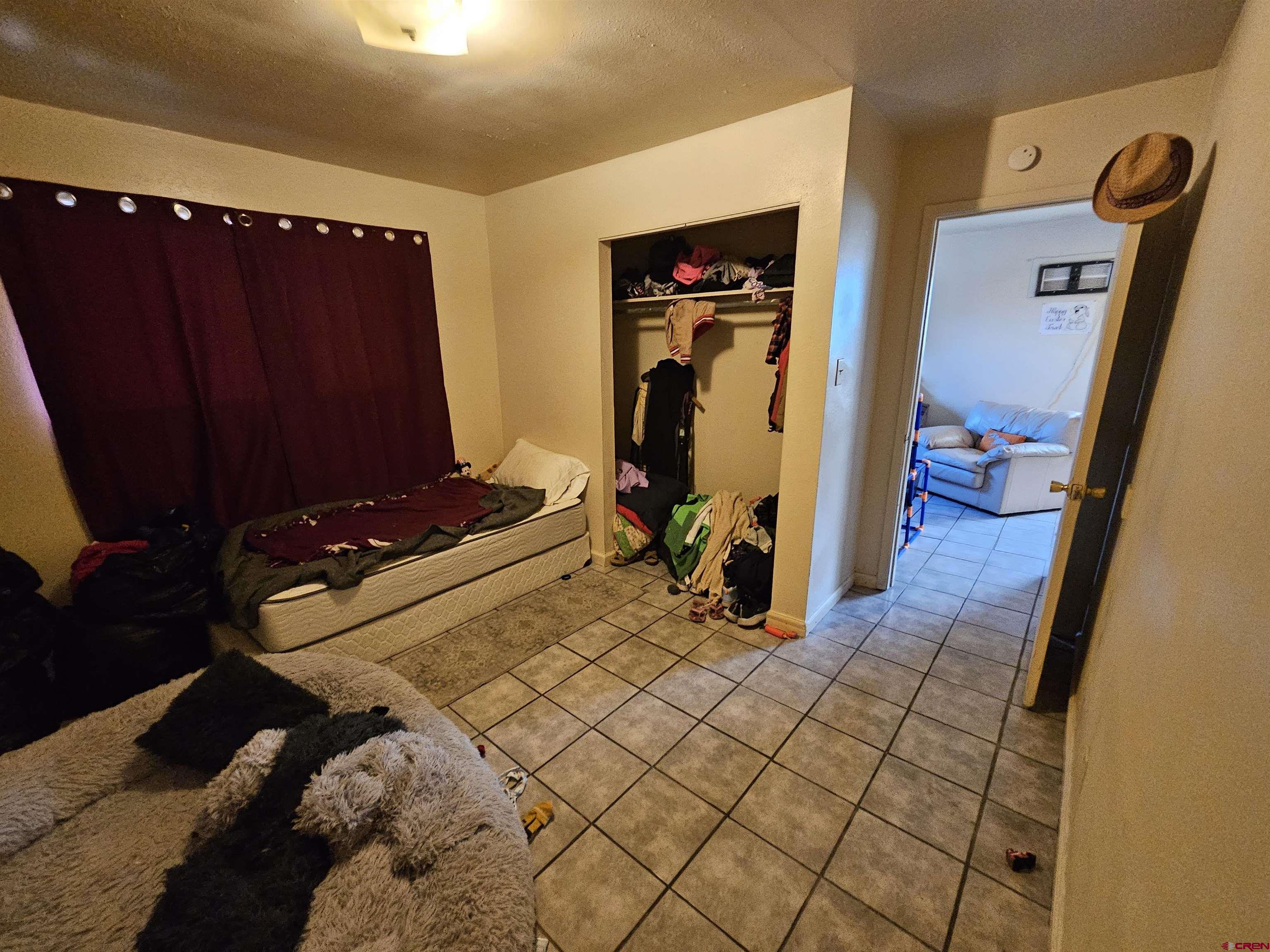 500 North 3rd Street Bloomfield, NM 87413 - Photo 3 of 33 a bedroom with a bed and a mirror on dresser