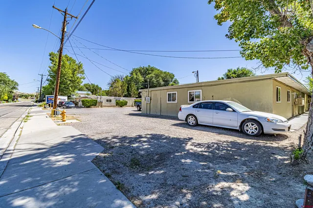 a view of a car in front of a building