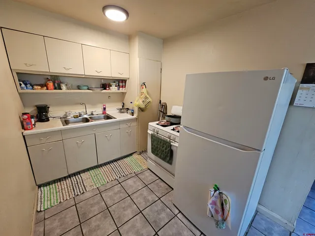 a kitchen with sink cabinets and appliances