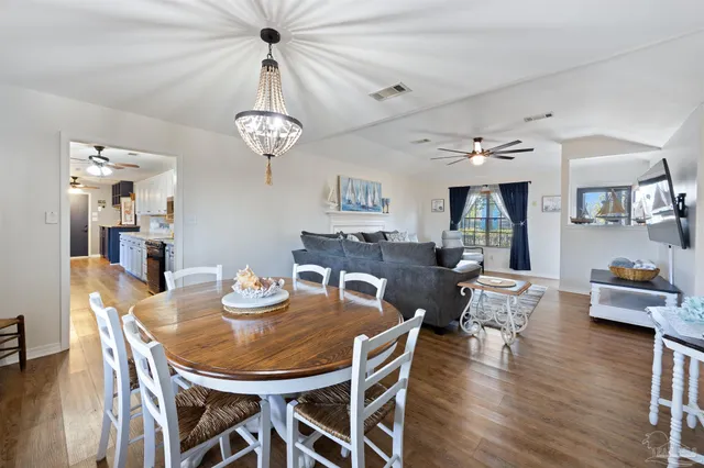 a kitchen with kitchen island granite countertop lots of counter top space a sink appliances and cabinets