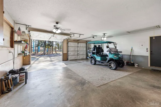 a view of a swimming pool with lawn chairs under an umbrella