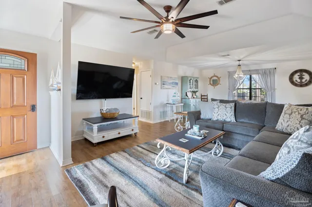 a living room with furniture and a flat screen tv