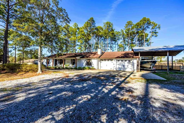 an aerial view of a house with a yard and lake view