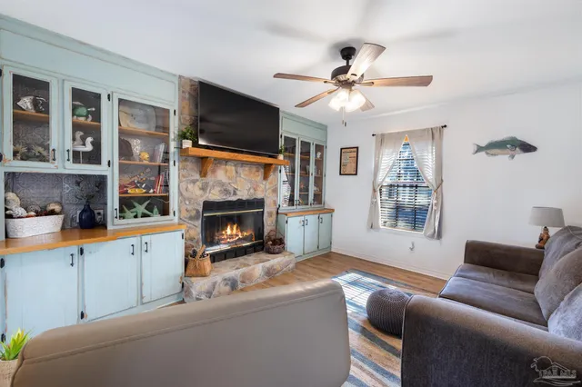 a view of a dining room with furniture a chandelier and wooden floor