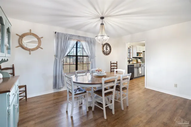 a view of a dining room with furniture wooden floor and chandelier