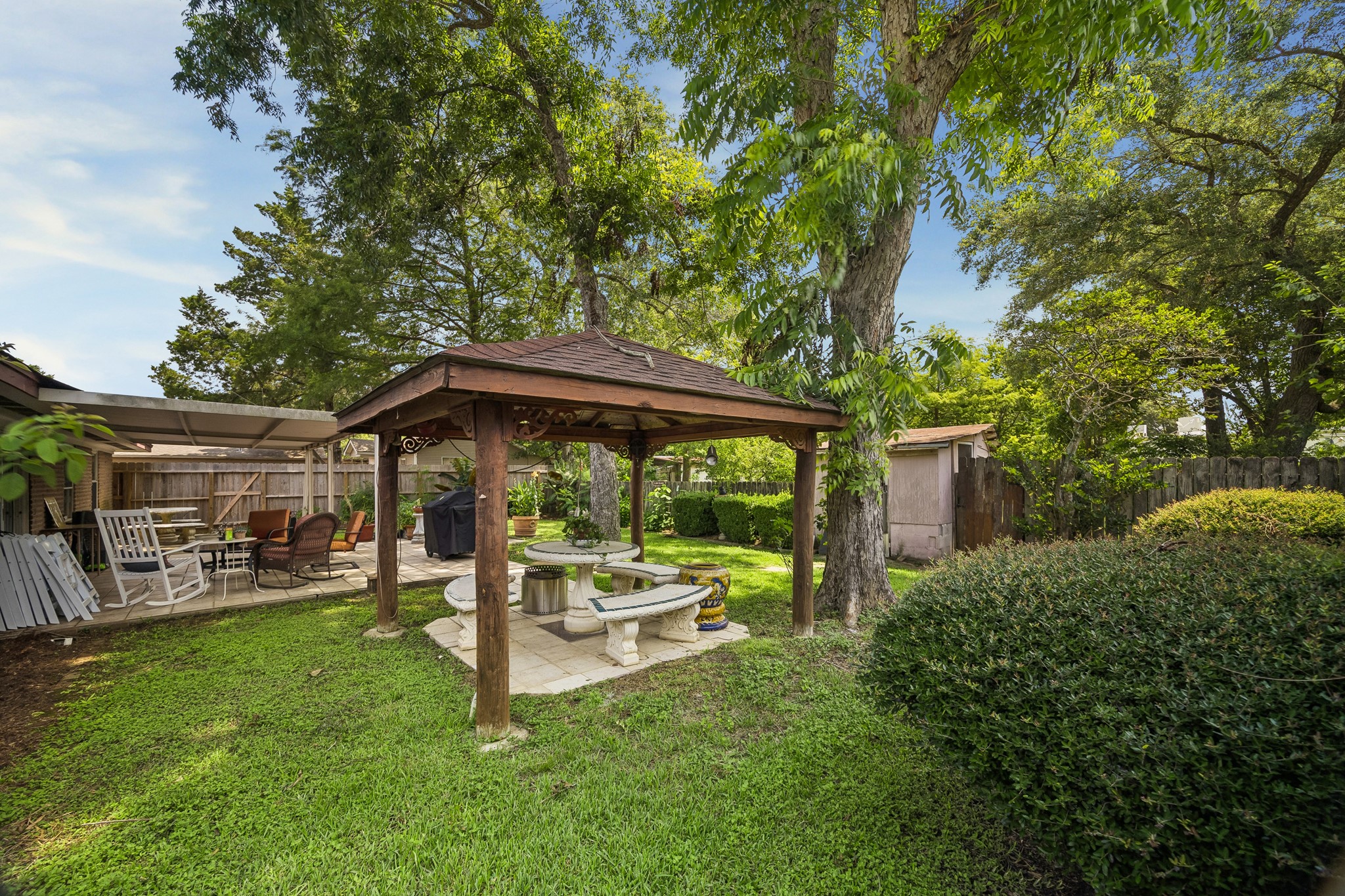 413 Mebane Lane Rosenberg, TX 77471 - Photo 30 of 30 This backyard features a charming gazebo surrounded by lush greenery and mature trees. It is the perfect place for outdoor entertaining.
