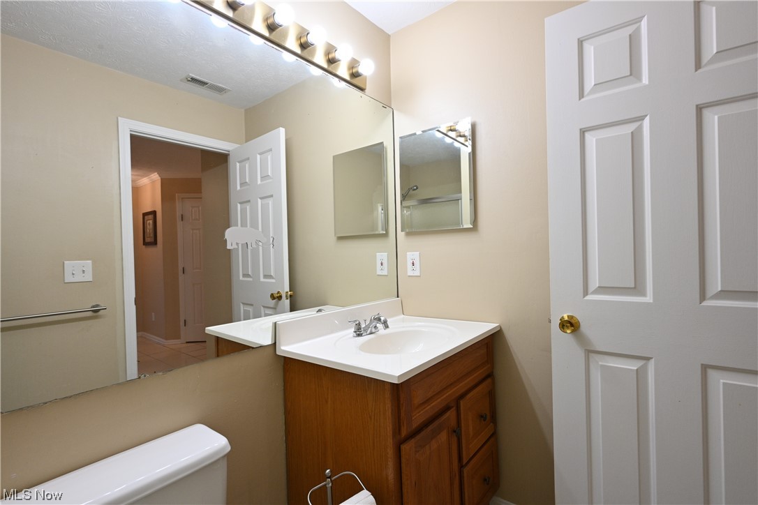 28140 Detroit Road, Unit A1 Westlake, OH 44145 - Photo 26 of 30 Bathroom featuring tile floors, large vanity, and toilet