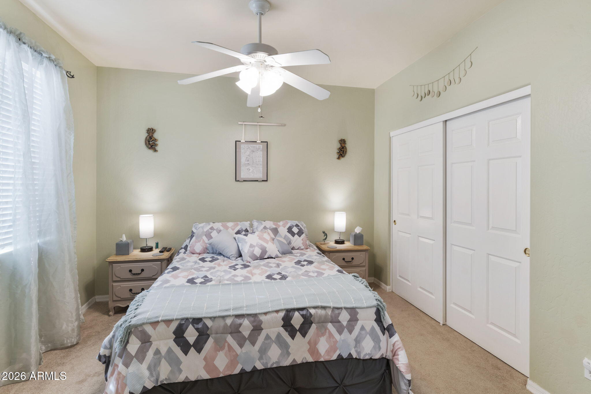4202 East Broadway Road, Unit 80 Mesa, AZ 85206 - Photo 20 of 68 a bedroom with a bed and a chandelier