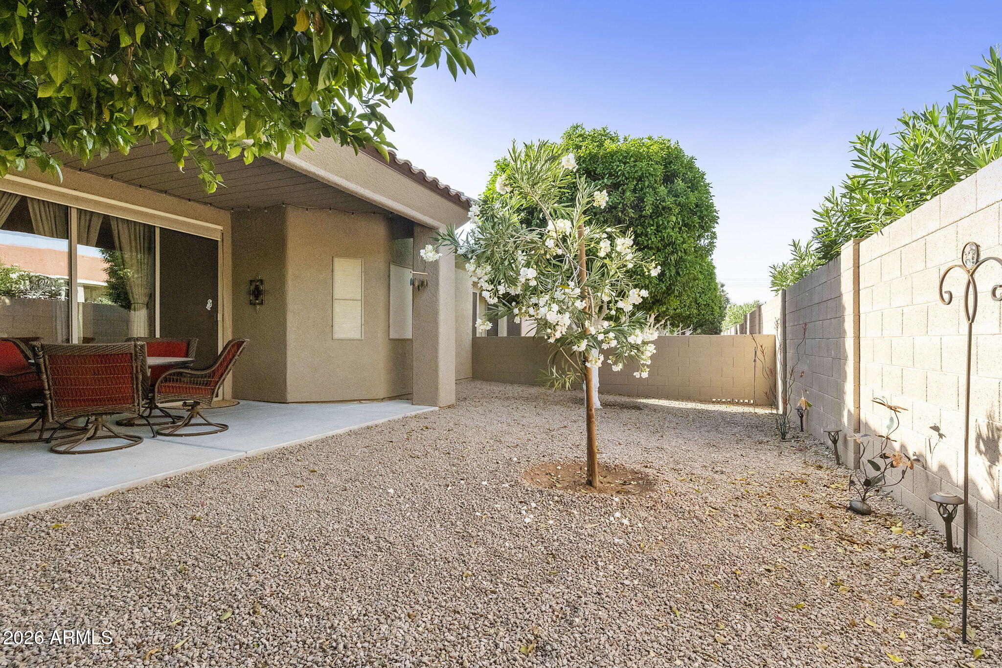 4202 East Broadway Road, Unit 80 Mesa, AZ 85206 - Photo 31 of 68 a backyard of a house with table and chairs