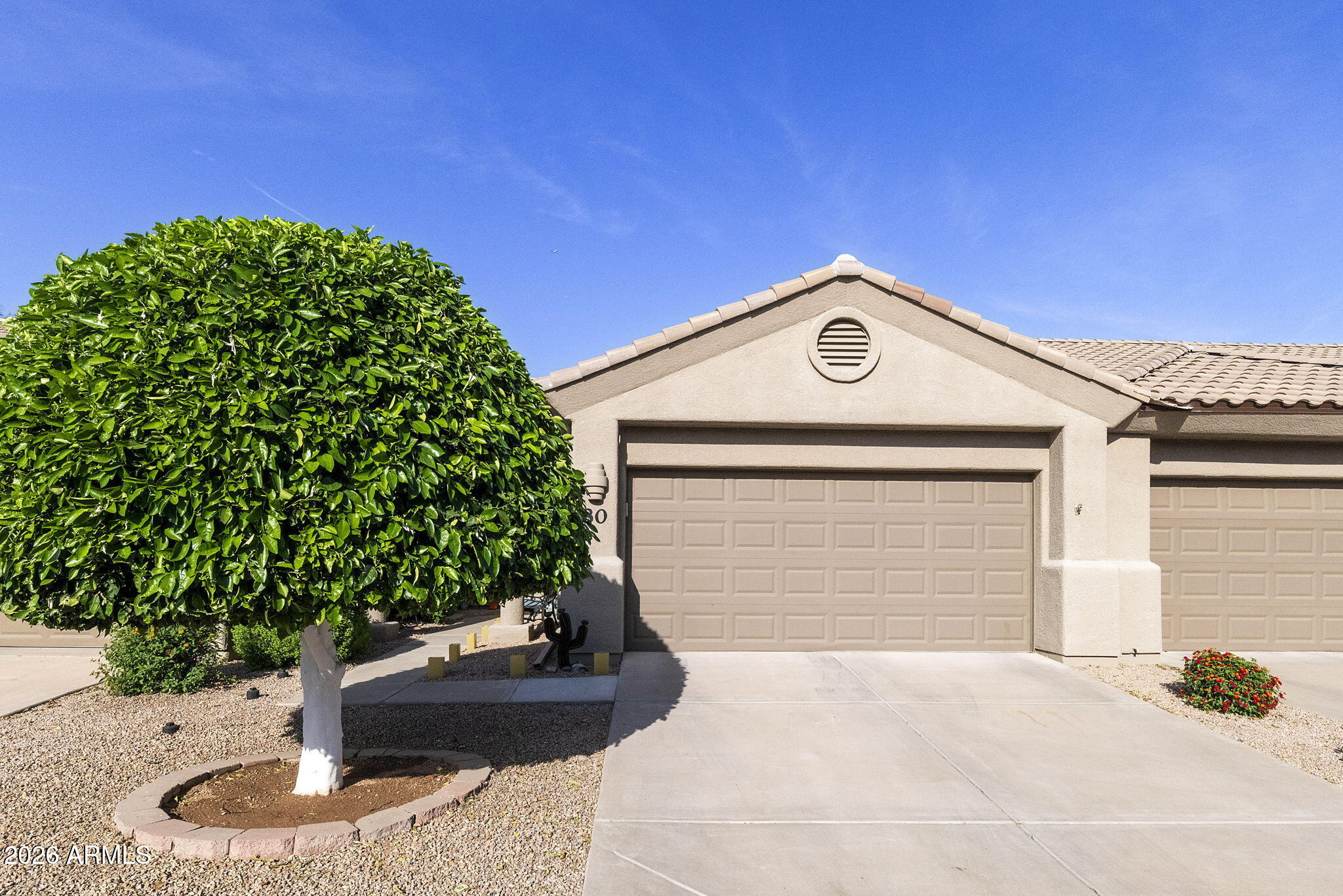 4202 East Broadway Road, Unit 80 Mesa, AZ 85206 - Photo 33 of 68 a front view of a house with a yard
