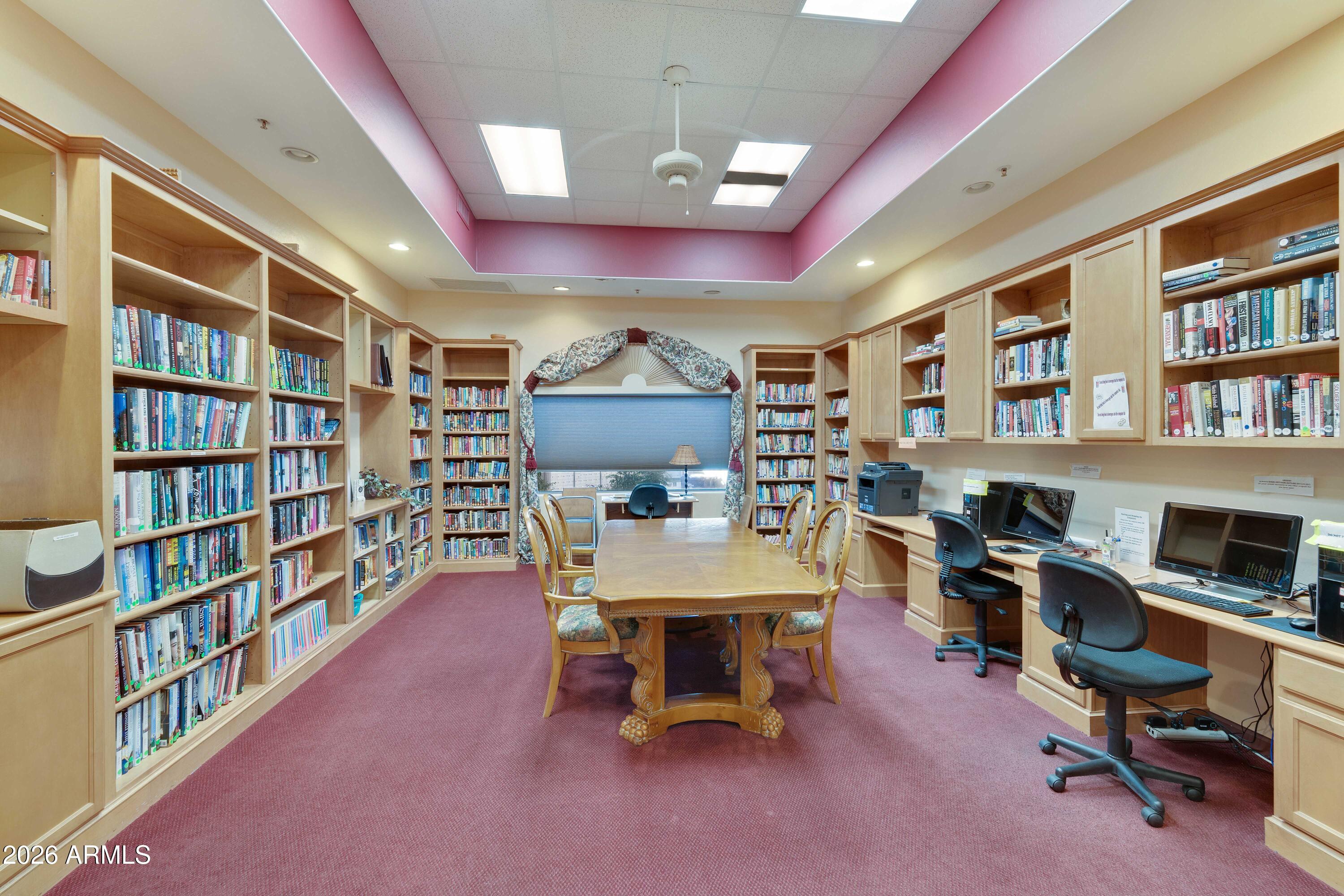 4202 East Broadway Road, Unit 80 Mesa, AZ 85206 - Photo 47 of 68 a view of a workspace with furniture and a bookshelf