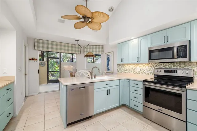 a kitchen with cabinets stainless steel appliances and a counter space
