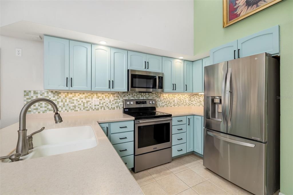 4480 Ascot Circle South Sarasota, FL 34235 - Photo 12 of 76 a kitchen with granite countertop a stainless steel appliances a refrigerator and a sink