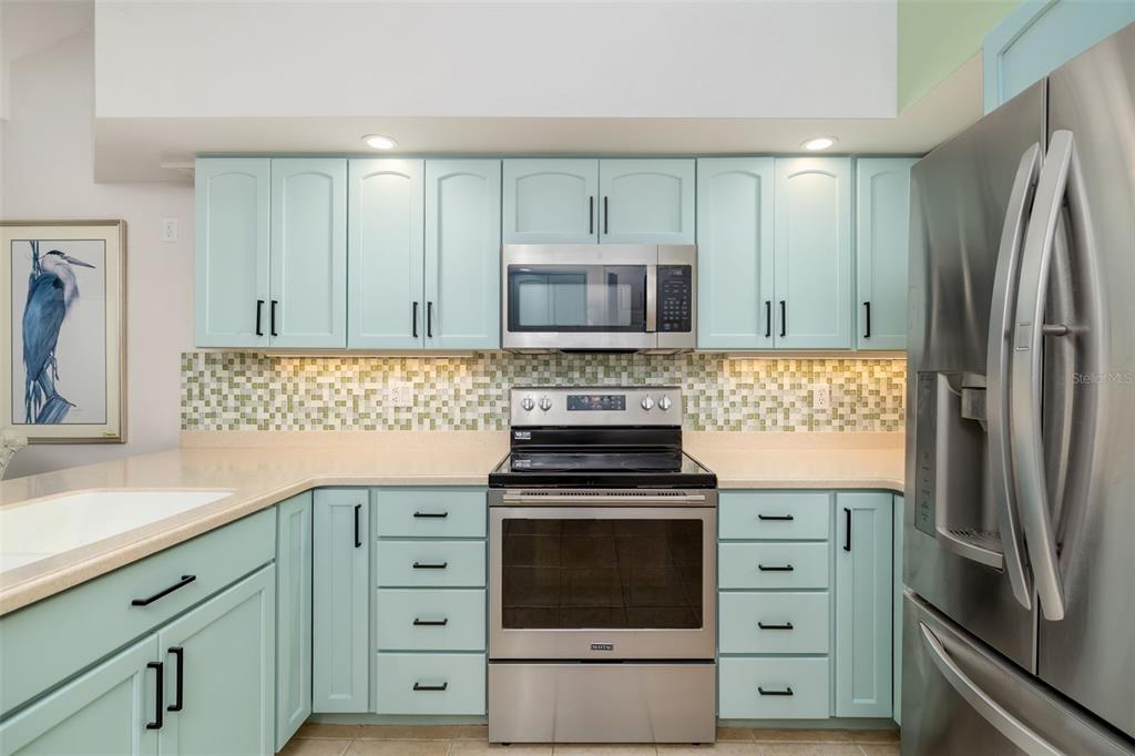 4480 Ascot Circle South Sarasota, FL 34235 - Photo 13 of 76 a kitchen with cabinets stainless steel appliances and a counter space