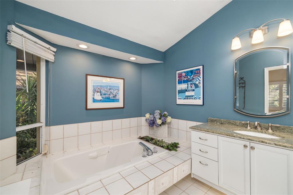 4480 Ascot Circle South Sarasota, FL 34235 - Photo 20 of 76 a bath room with a sink and a mirror