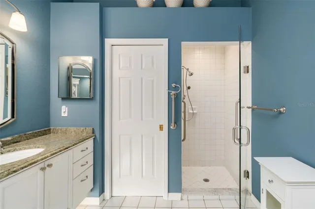 a bathroom with a glass shower door