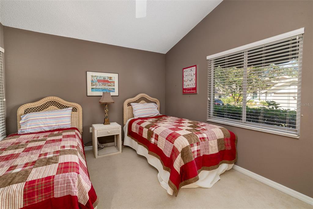 4480 Ascot Circle South Sarasota, FL 34235 - Photo 25 of 76 a bedroom with two beds and a window