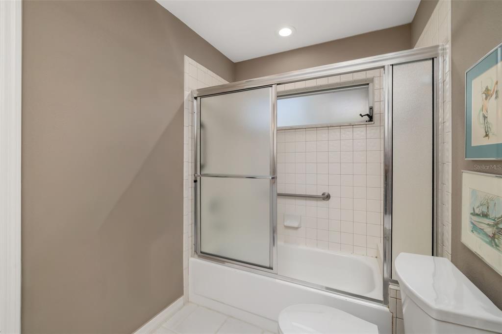 4480 Ascot Circle South Sarasota, FL 34235 - Photo 26 of 76 a bathroom with a glass shower door