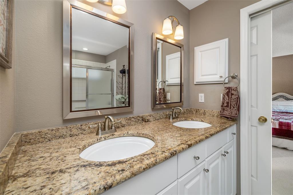 4480 Ascot Circle South Sarasota, FL 34235 - Photo 27 of 76 a bathroom with a granite countertop double vanity sinks and a mirror
