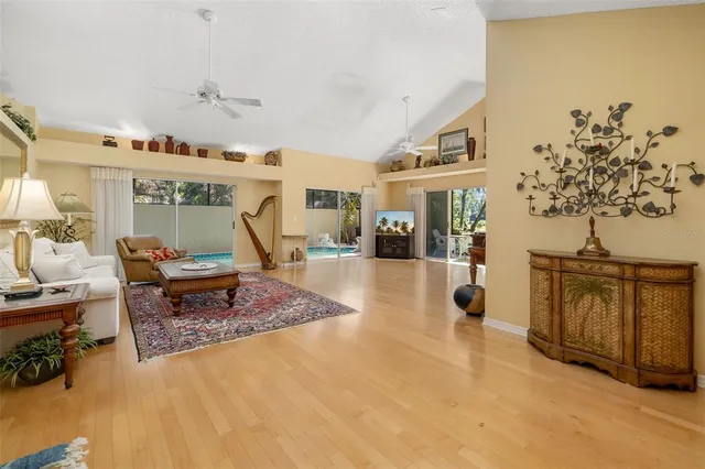 a view of a livingroom with furniture wooden floor and a fireplace
