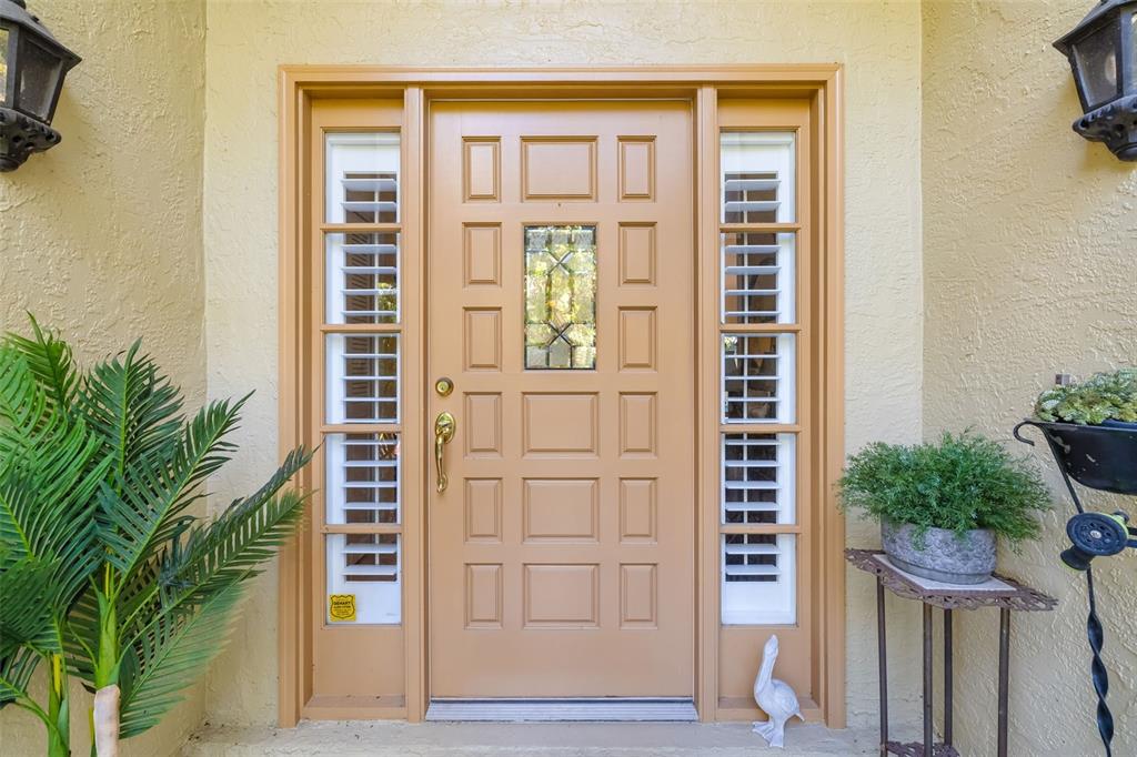 4480 Ascot Circle South Sarasota, FL 34235 - Photo 40 of 76 a view of front door and potted plants