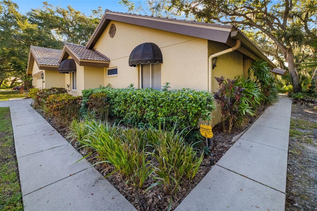 4480 Ascot Circle South Sarasota, FL 34235 - Photo 44 of 76 a front view of a house with garden
