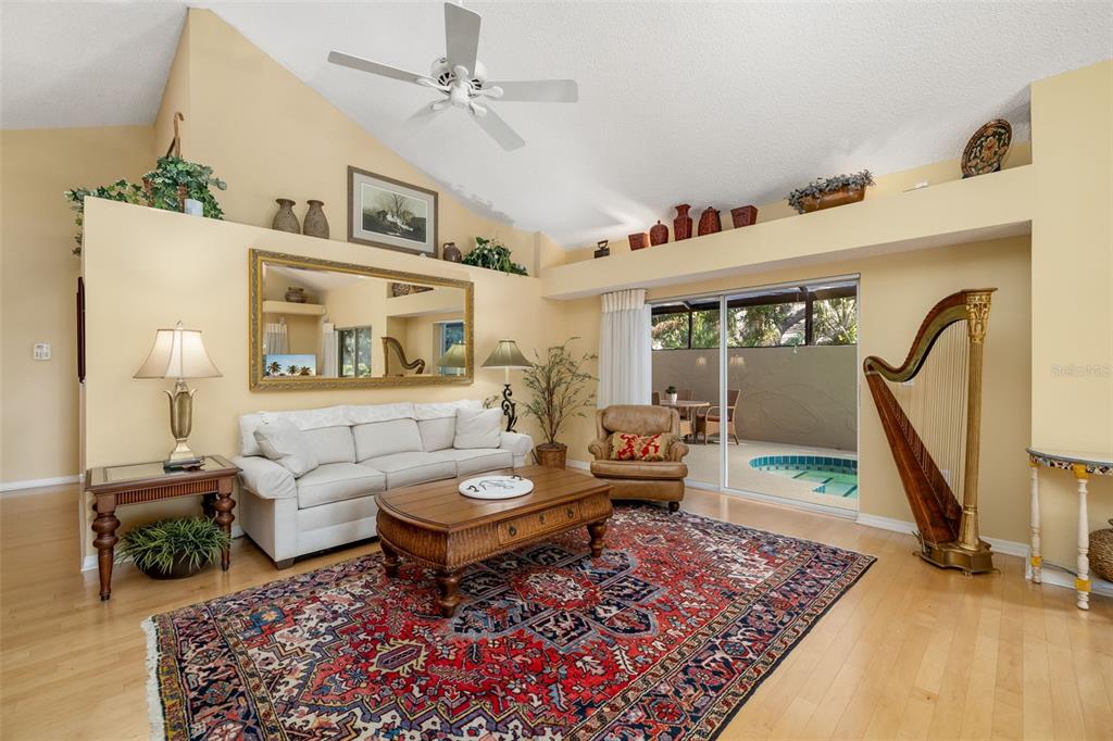 4480 Ascot Circle South Sarasota, FL 34235 - Photo 6 of 76 a living room with furniture and a rug