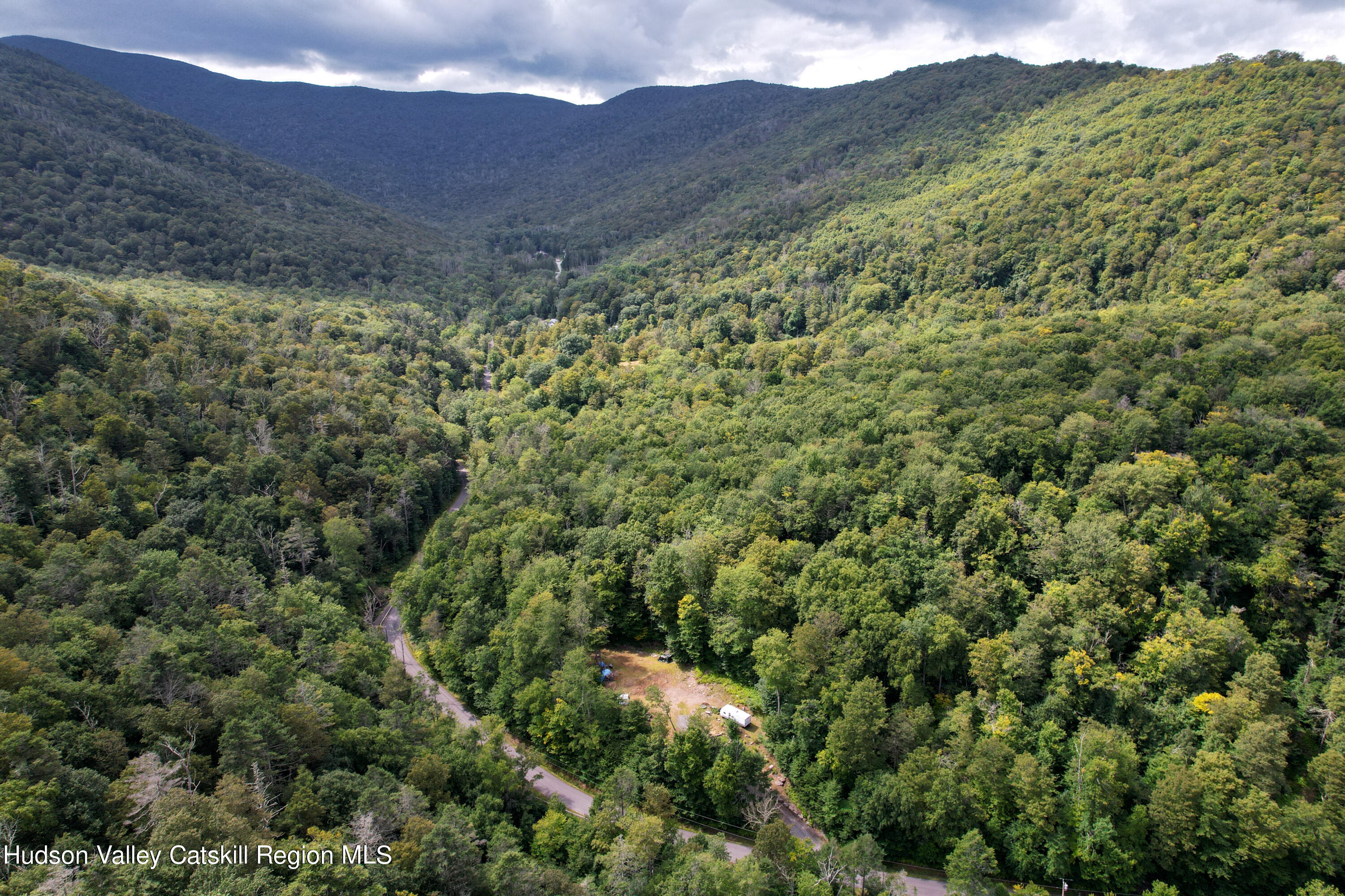 208 Pantherkill Road Phoenicia, NY 12464 - Photo 6 of 16 a view of a big yard with mountains in the background