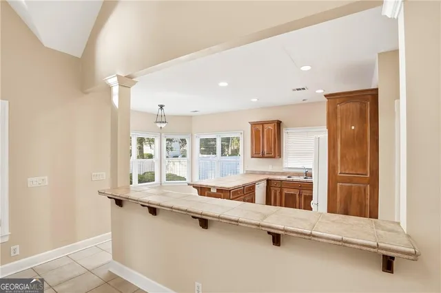 a kitchen with granite countertop a sink and a stove top oven