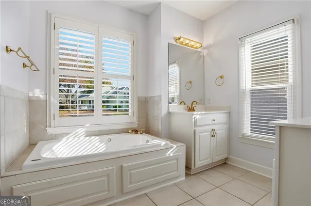 a spacious bathroom with a shower sink and mirror