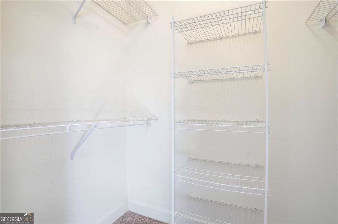 171 West Commons Drive St. Simons, GA 31522 - Photo 20 of 39 a view of walk in closet with empty racks