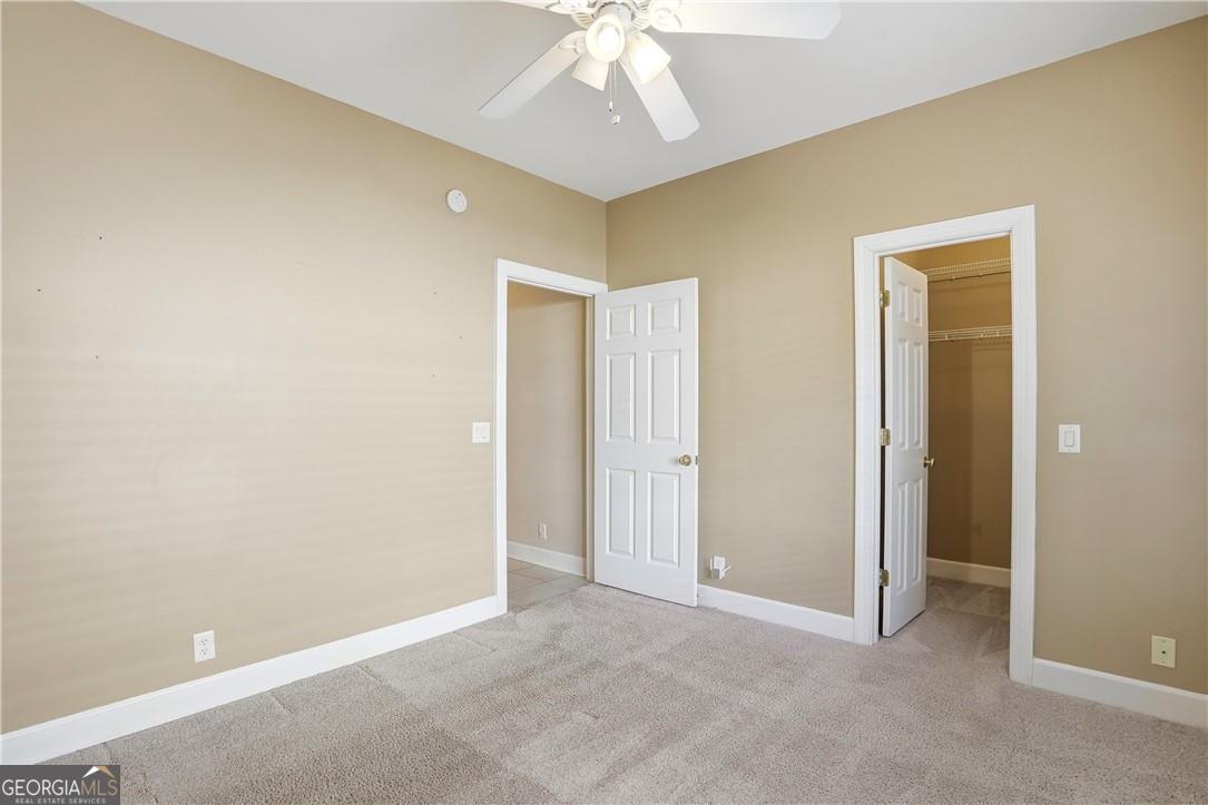 171 West Commons Drive St. Simons, GA 31522 - Photo 25 of 39 an empty room with chandelier fan and closet area