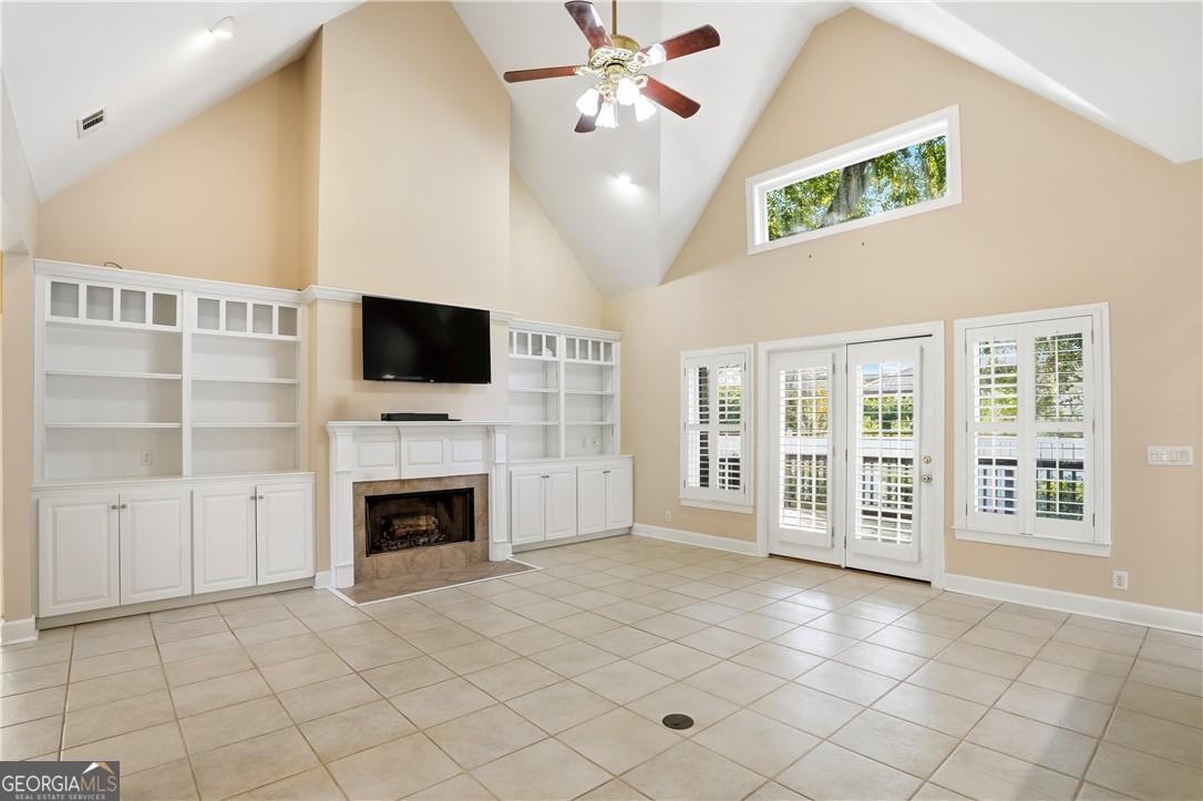 171 West Commons Drive St. Simons, GA 31522 - Photo 6 of 39 a view of an empty room with a fireplace and a window