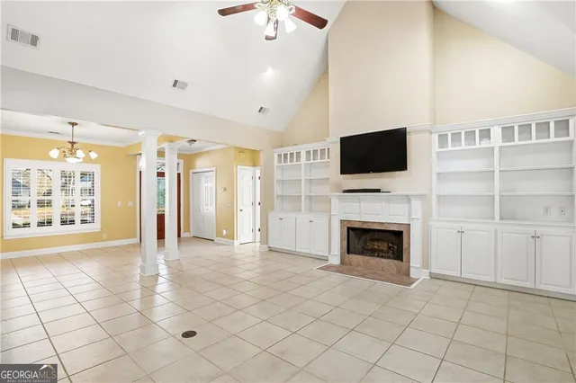a view of a livingroom with an empty space and a fireplace