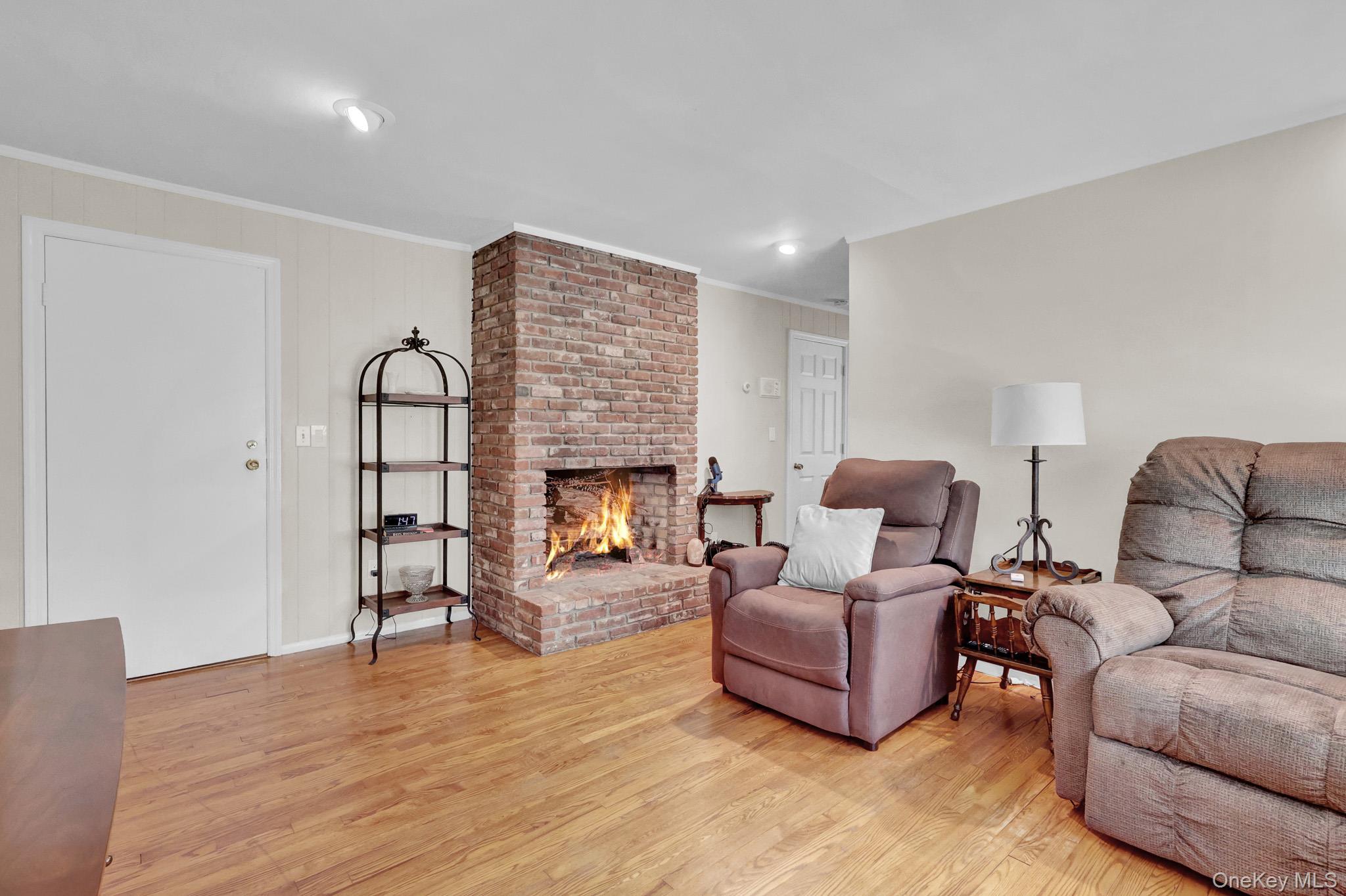 121 Old Field Road Huntington, NY 11743 - Photo 29 of 38 Apartment’s roomy living room with Masonery brick fireplace and hardwood floors.