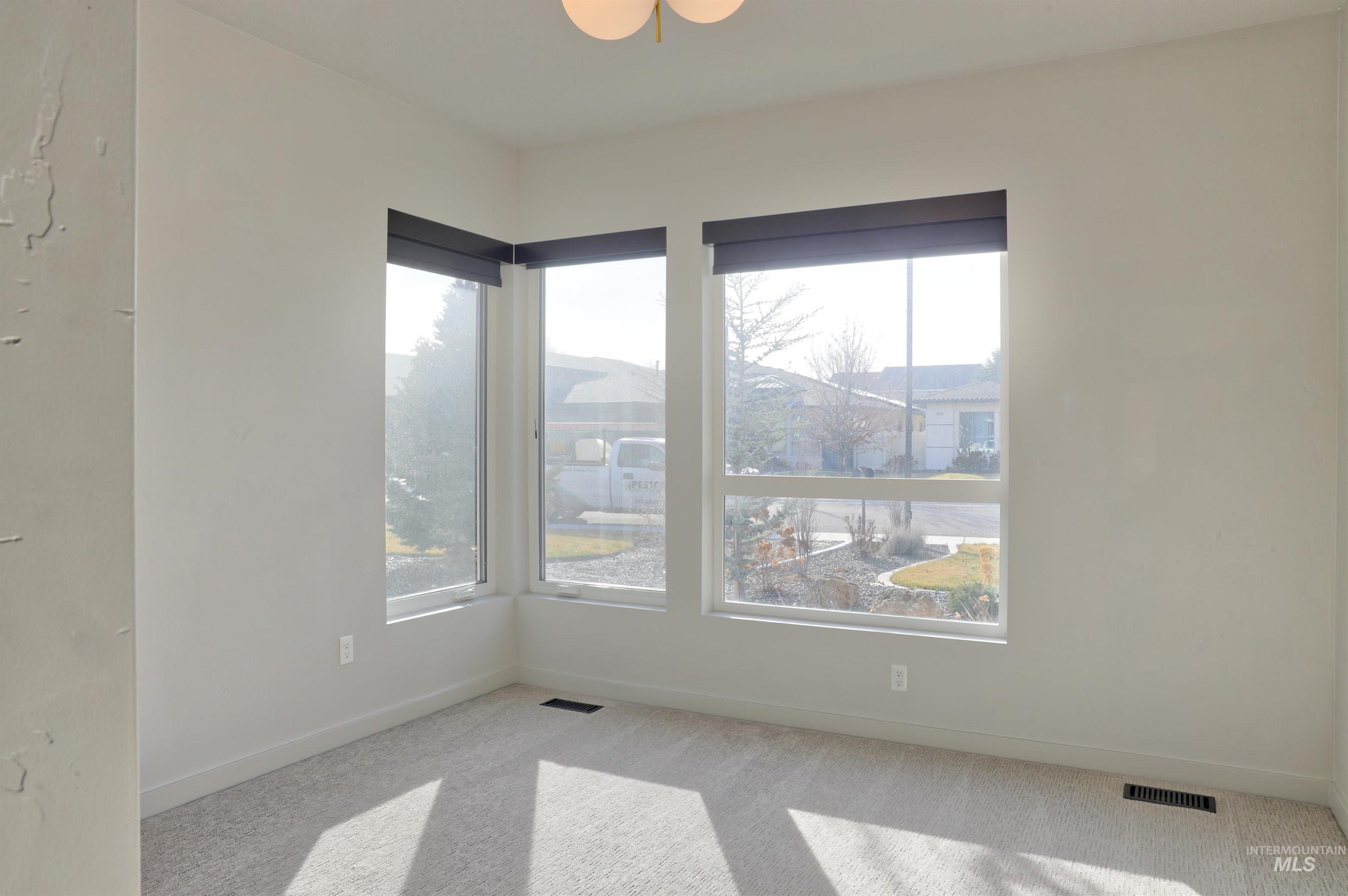 4148 East Copper Point Drive Meridian, ID 83642 - Photo 14 of 26 Empty room featuring baseboards and light colored carpet