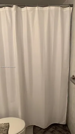 a bathroom with a glass shower door