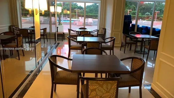 a view of a dining room with furniture and window