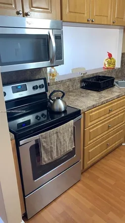 a stove top oven sitting inside of a kitchen