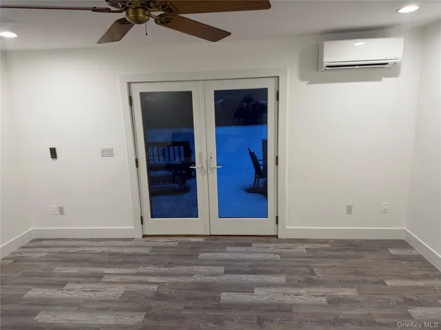 a view of a room with wooden floor and window