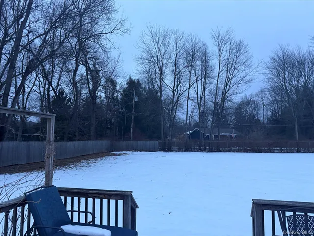 a view of a chairs and table on the roof deck