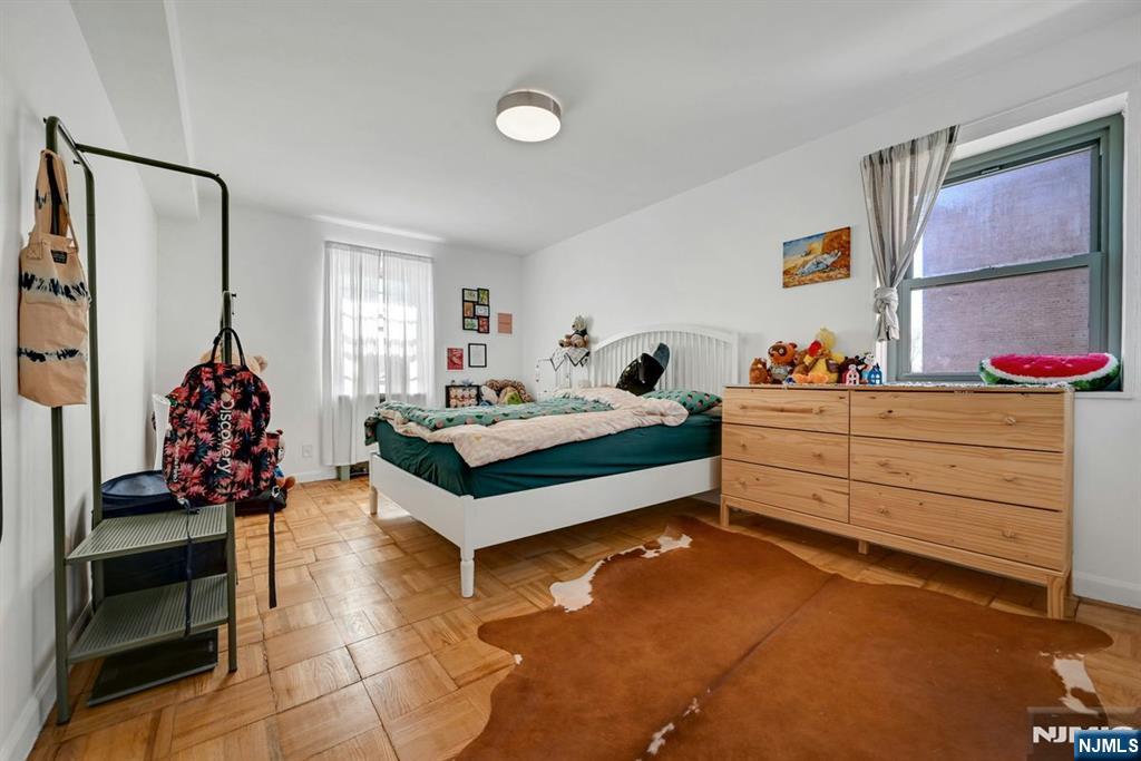 208 Anderson Street, Unit S5A Hackensack, NJ 07601 - Photo 11 of 17 a bedroom with a bed and a dresser