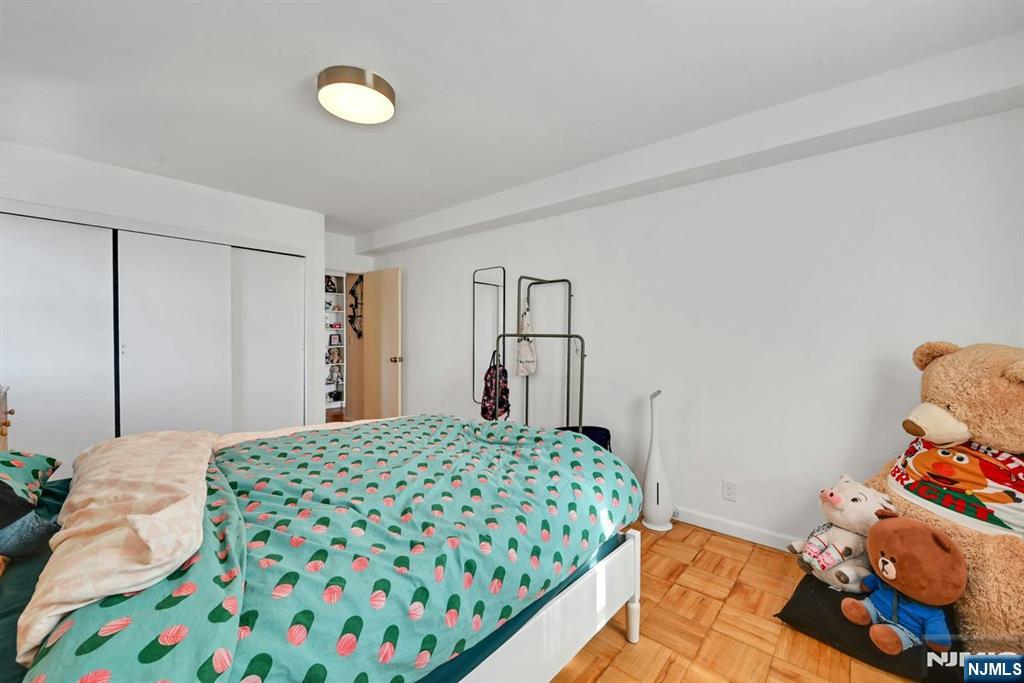 208 Anderson Street, Unit S5A Hackensack, NJ 07601 - Photo 12 of 17 a bedroom with a bed and a dresser in it