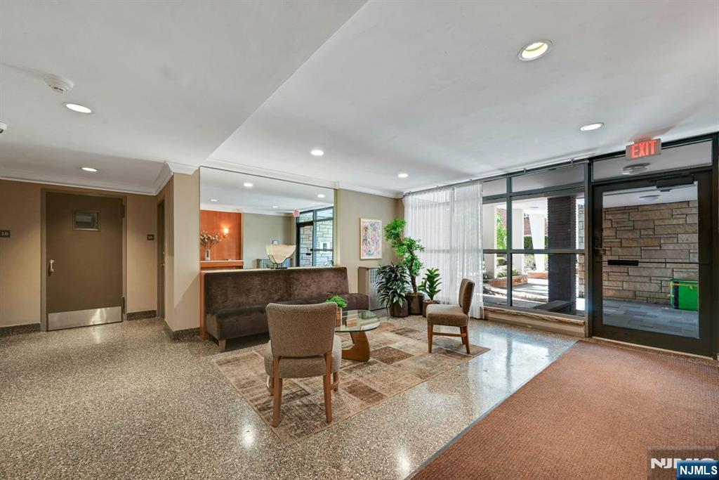 208 Anderson Street, Unit S5A Hackensack, NJ 07601 - Photo 15 of 17 a living room with furniture and a large window