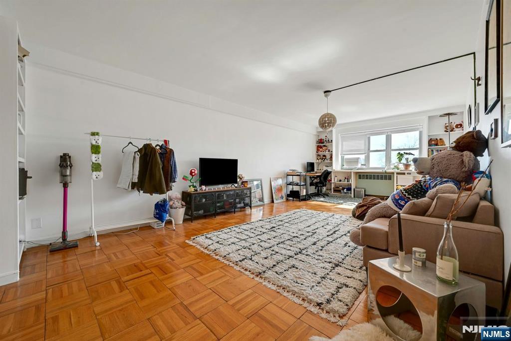 208 Anderson Street, Unit S5A Hackensack, NJ 07601 - Photo 4 of 17 a bedroom with furniture and a flat screen tv