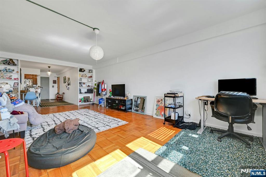 208 Anderson Street, Unit S5A Hackensack, NJ 07601 - Photo 5 of 17 a living room with furniture and a flat screen tv