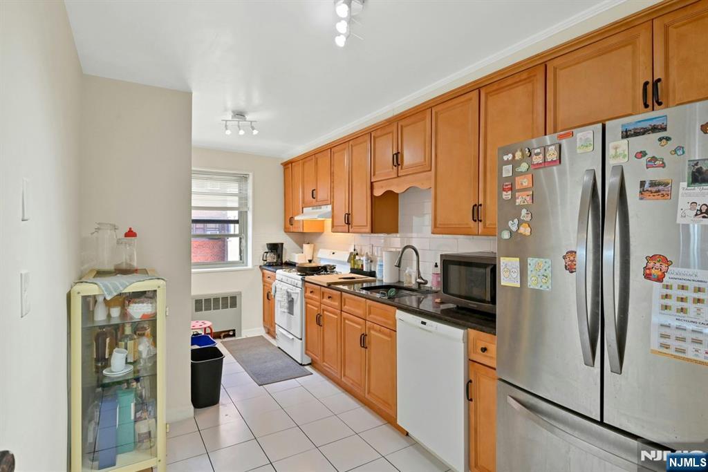 208 Anderson Street, Unit S5A Hackensack, NJ 07601 - Photo 9 of 17 a kitchen with stainless steel appliances a refrigerator sink and cabinets